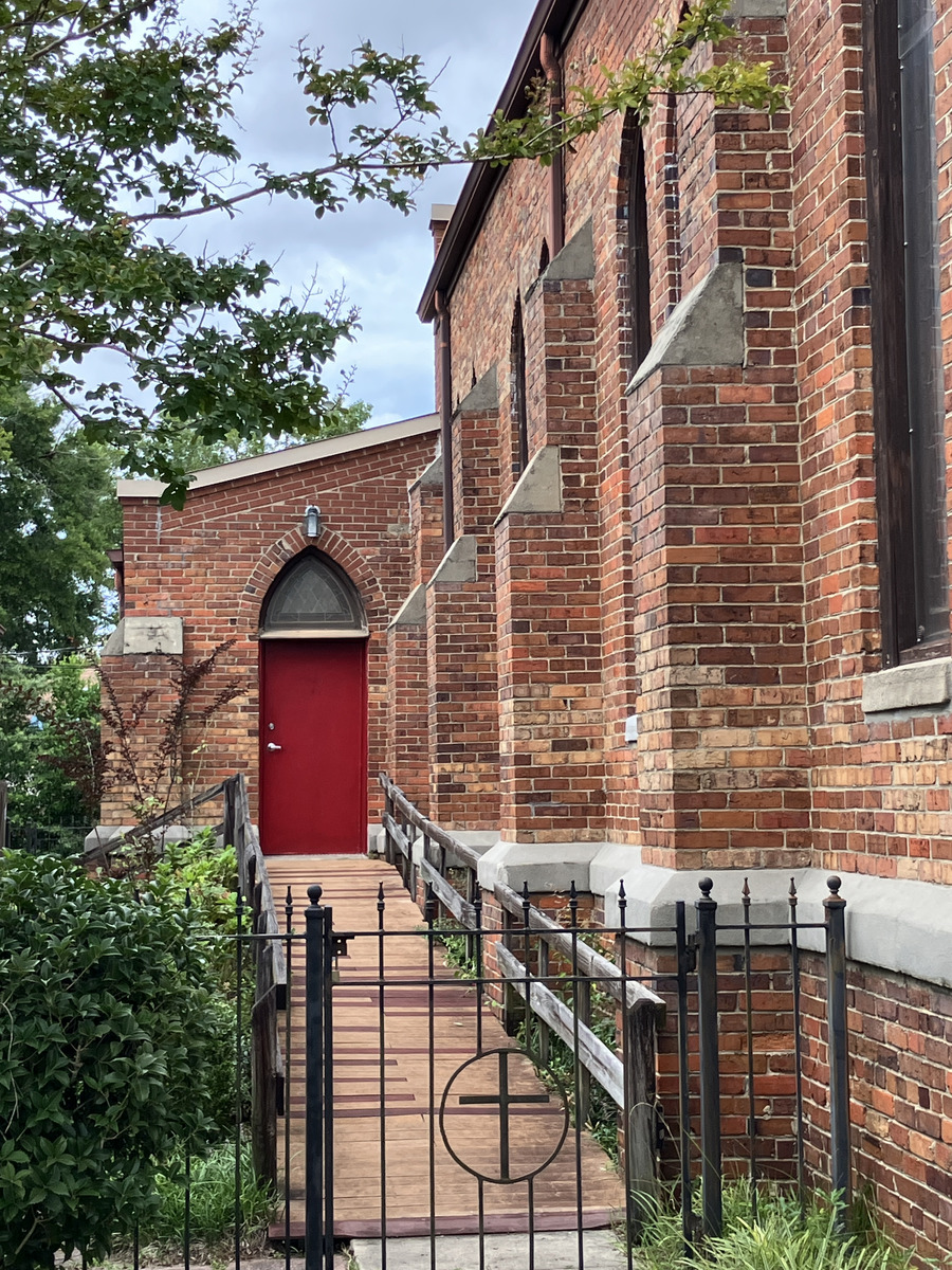 Church of the Good Shepherd: red side entrance and churchyard
