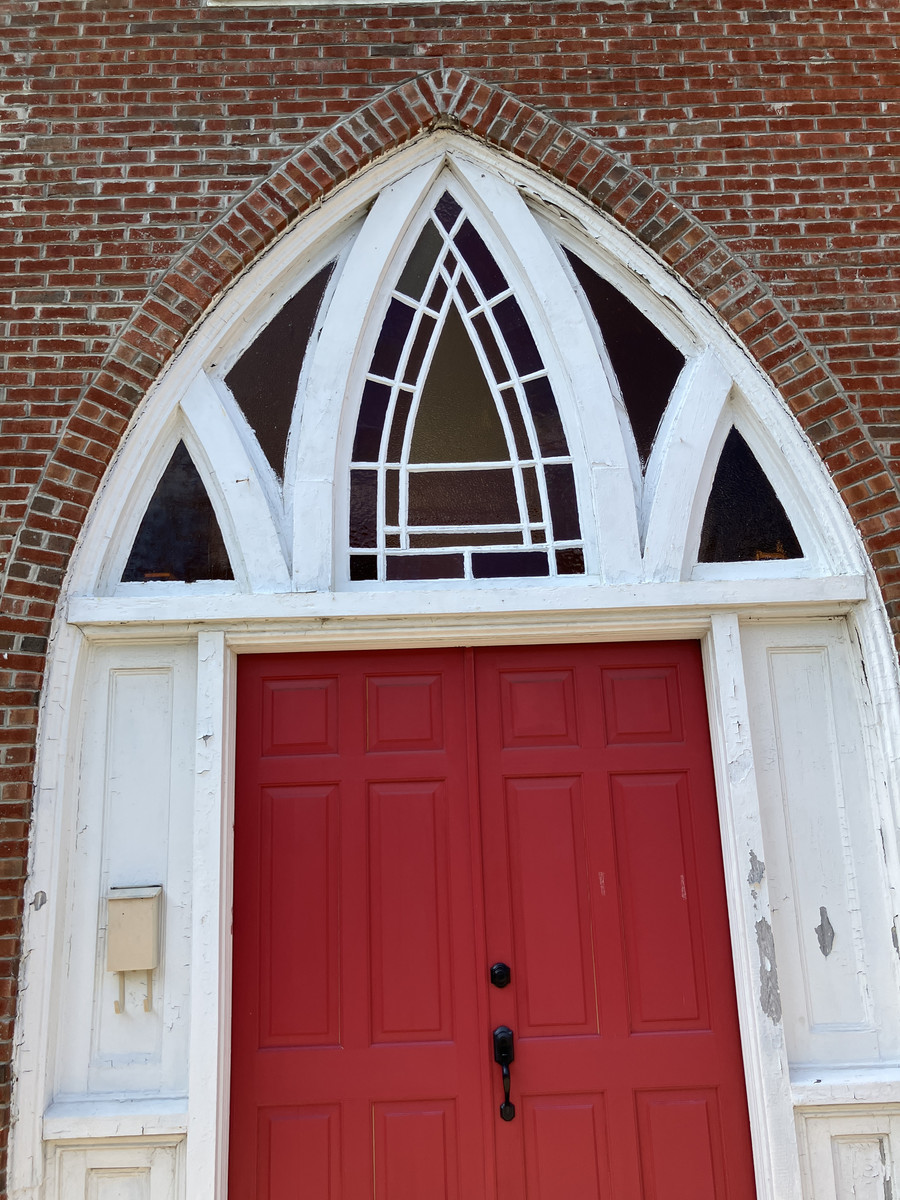 Gregory Congregational Church U.C.C.: red entrance doors and pointed-arch tracery
