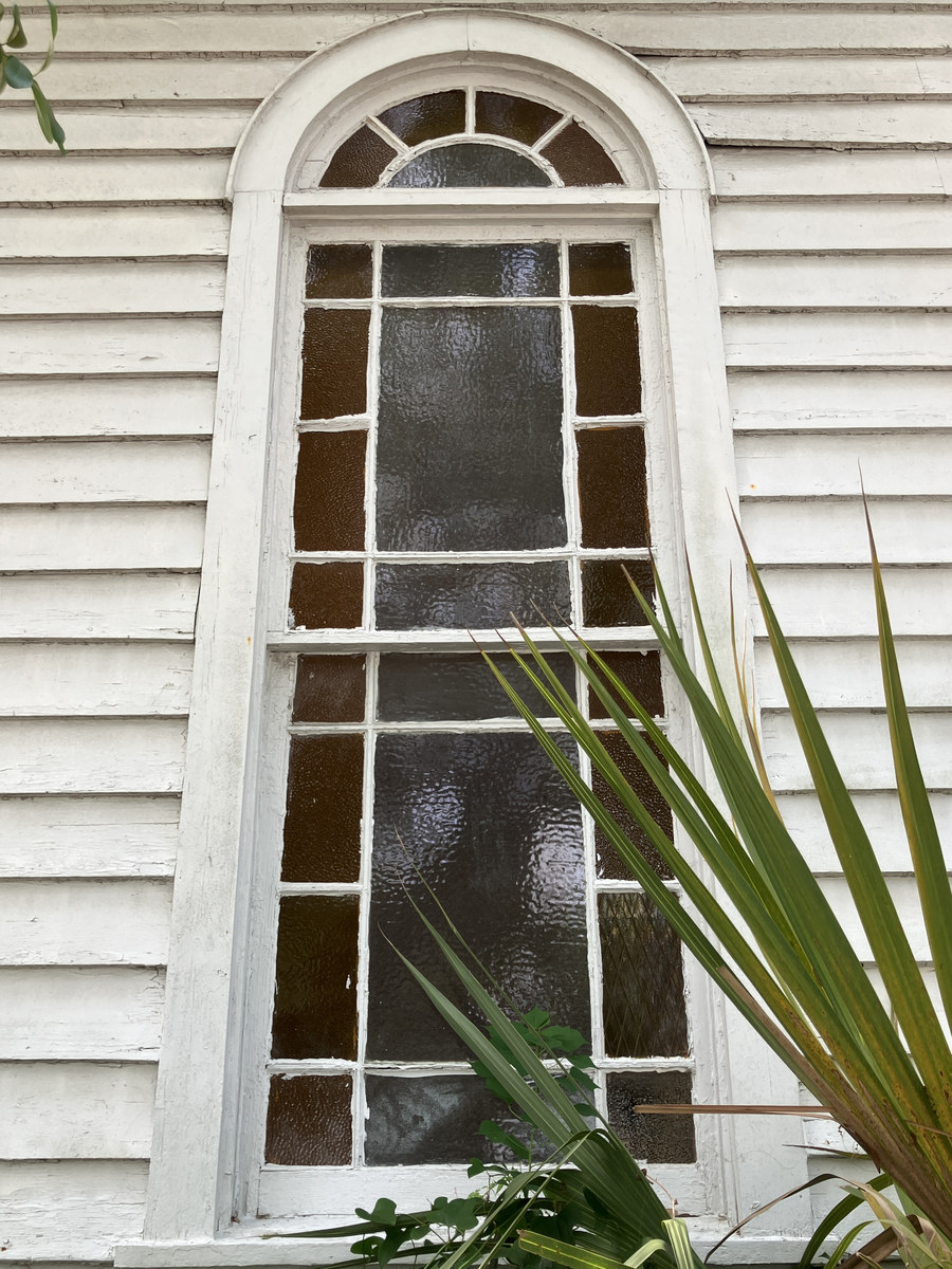 Maranatha Temple of Praise: arched window and clapboard detail