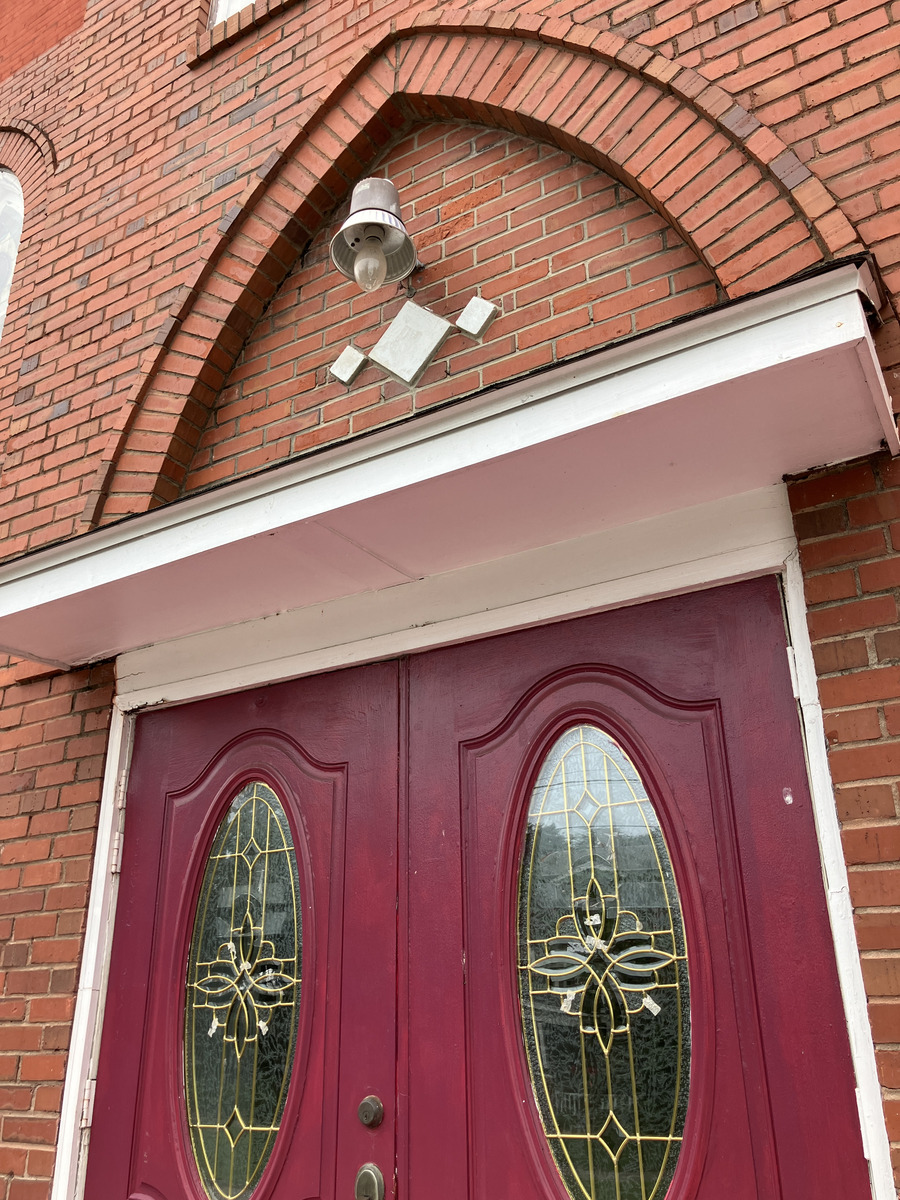 Mount Zion A.M.E. Church: red entrance doors and brick arch detail