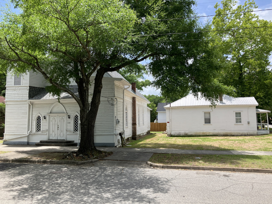 New Jerusalem Missionary Baptist Church: wide streetscape view beneath the mature oak