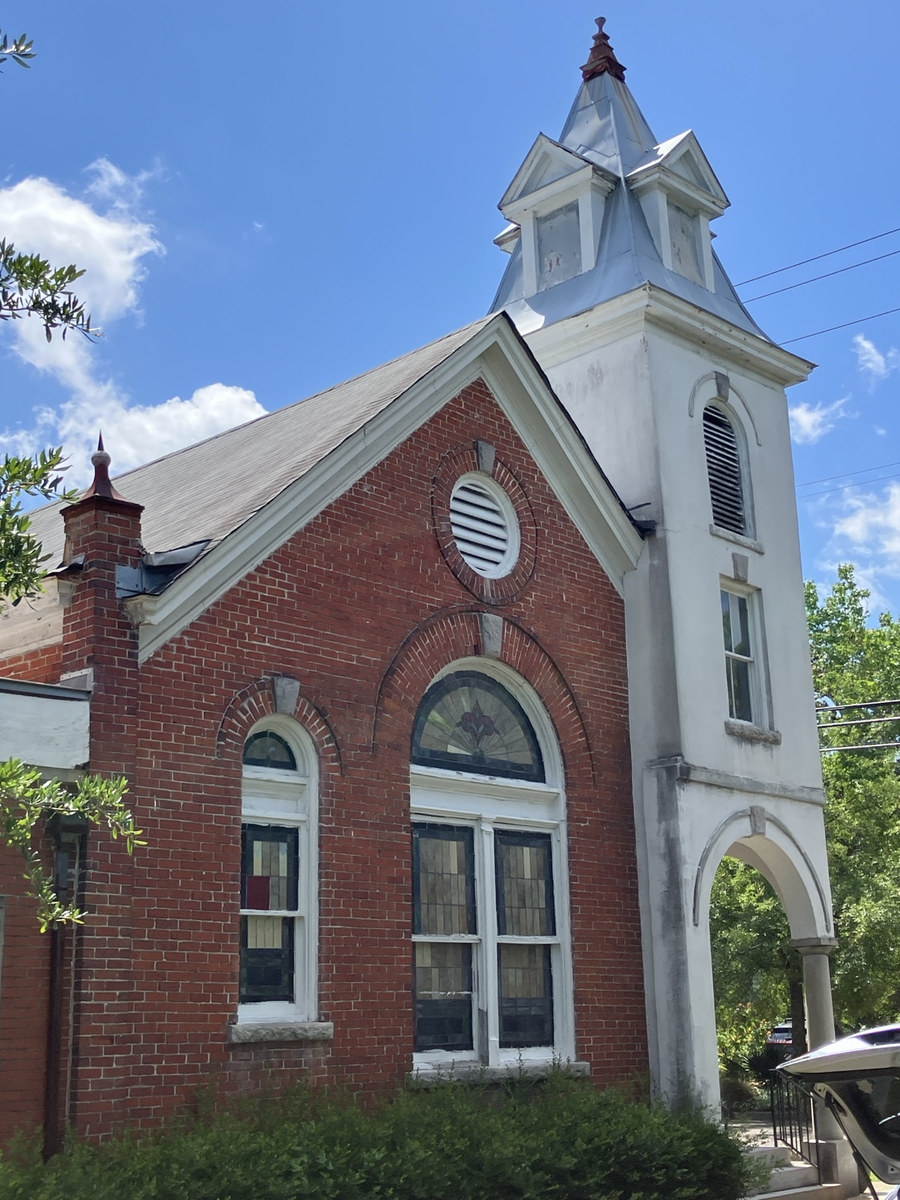 Holy Ghost Deliverance Tabernacle of Prayer: close architectural view of the arched windows, brickwork, and tower
