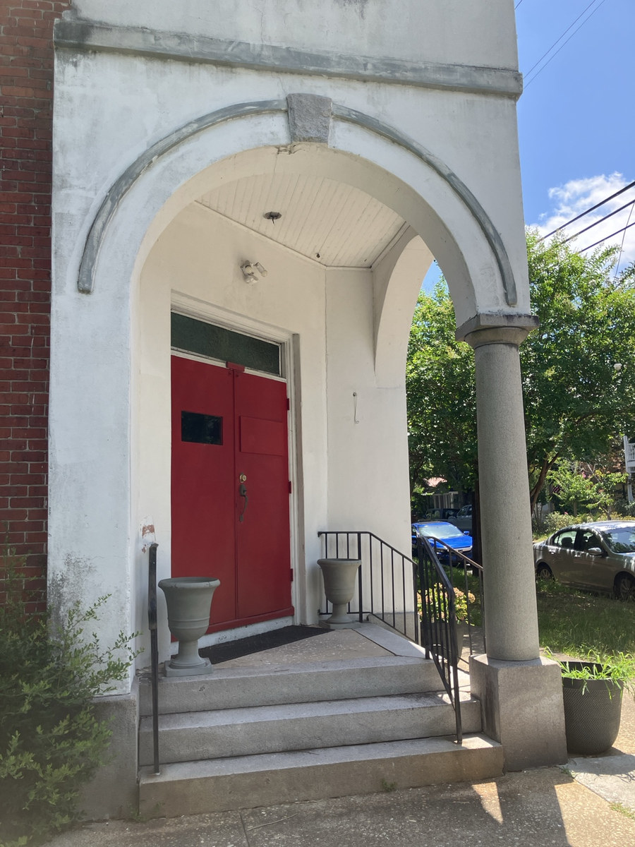 Holy Ghost Deliverance Tabernacle of Prayer: red entrance doors beneath the tower arch