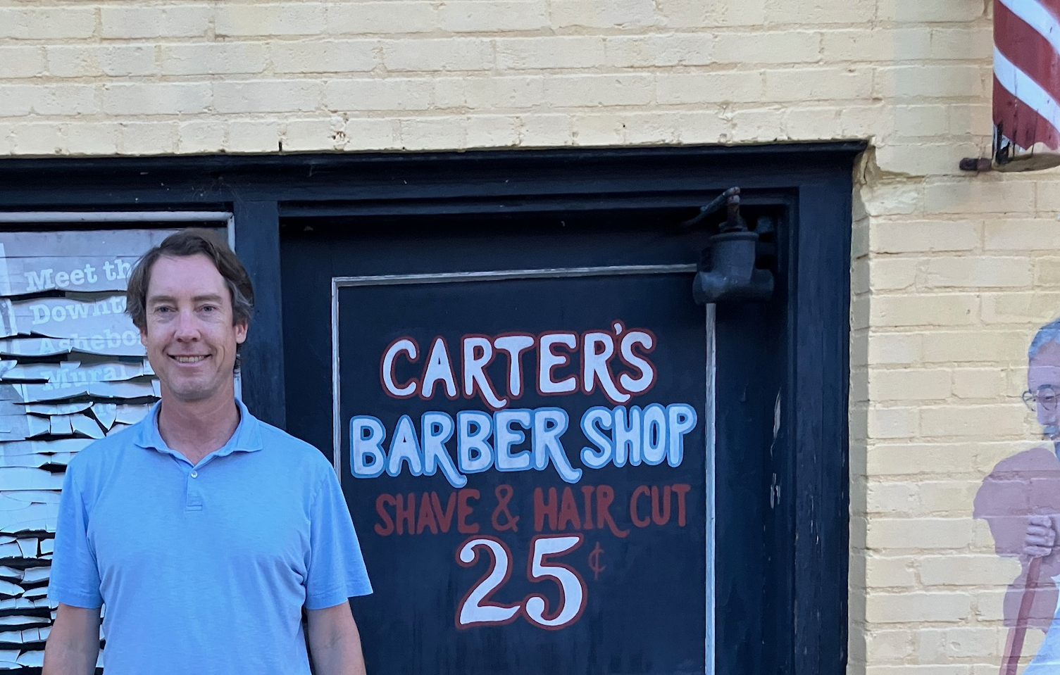 Beside the painted Carter's Barber Shop sign.